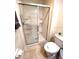 Bathroom with a glass-enclosed shower and toilet at 3014 Red Ginger Rd, Kissimmee, FL 34747