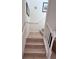 Bright staircase with hardwood steps and white railing offers a smooth transition between floors at 3014 Red Ginger Rd, Kissimmee, FL 34747
