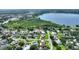 A beautiful aerial view showing the neighborhood, backing up to green space and a scenic lake at 31 Lake Link Se Cir, Winter Haven, FL 33884
