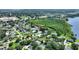 Beautiful aerial view of the neighborhood with lush trees, community, and distant water feature at 31 Lake Link Se Cir, Winter Haven, FL 33884