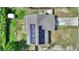 Birds eye view of home and solar panels with fenced yard at 31 Lake Link Se Cir, Winter Haven, FL 33884
