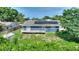 Backyard with a deck, fire pit, and storage shed in a fenced yard with mature trees at 31 Lake Link Se Cir, Winter Haven, FL 33884