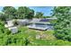 Backyard with a deck, fire pit, and storage shed in a fenced yard with mature trees at 31 Lake Link Se Cir, Winter Haven, FL 33884