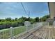 Backyard deck with a white railing and green grass lawn in background at 31 Lake Link Se Cir, Winter Haven, FL 33884