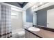 Bathroom with shower-tub combo, toilet, and vanity with a large, lighted mirror at 31 Lake Link Se Cir, Winter Haven, FL 33884