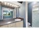 Bathroom showcasing updated vanity, lighting, and mirror plus a shower stall with modern tile at 31 Lake Link Se Cir, Winter Haven, FL 33884