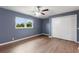 Bedroom features wood-look flooring, window with natural light, and closet with folding doors at 31 Lake Link Se Cir, Winter Haven, FL 33884
