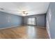 Spacious bedroom featuring hardwood floors, a ceiling fan, and a bright window at 31 Lake Link Se Cir, Winter Haven, FL 33884