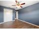Bedroom featuring wood-look flooring, a ceiling fan, and a closet with folding doors at 31 Lake Link Se Cir, Winter Haven, FL 33884