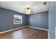 Bedroom featuring wood-look flooring, a ceiling fan, and a window with natural light at 31 Lake Link Se Cir, Winter Haven, FL 33884