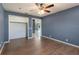 View of bedroom featuring wood-look floors and closet, with a view into the living room at 31 Lake Link Se Cir, Winter Haven, FL 33884