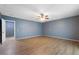 Bedroom featuring hardwood floors, a ceiling fan, and a doorway leading to another room at 31 Lake Link Se Cir, Winter Haven, FL 33884