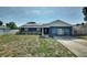 Charming single story home with brick facade, solar panels, and landscaped front yard at 31 Lake Link Se Cir, Winter Haven, FL 33884