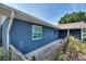 Brick home with blue paint, a window, and a gray walkway outside at 31 Lake Link Se Cir, Winter Haven, FL 33884
