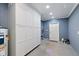 Garage interior with storage cabinets and door leading outside at 31 Lake Link Se Cir, Winter Haven, FL 33884