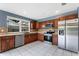 Bright kitchen features stainless steel appliances, tile backsplash, and wooden cabinets at 31 Lake Link Se Cir, Winter Haven, FL 33884