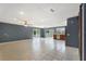 Open living space with tile flooring, ceiling fan, and sliding doors to outdoor deck at 31 Lake Link Se Cir, Winter Haven, FL 33884