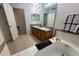 Well-lit bathroom features a double vanity, soaking tub, and tile flooring at 315 Wildflower Rd, Davenport, FL 33837