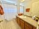 Bathroom with a toilet, bathtub, vanity and tile flooring at 315 Wildflower Rd, Davenport, FL 33837