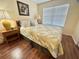 Cozy bedroom with a wooden floor, a window and a bed at 315 Wildflower Rd, Davenport, FL 33837