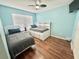 Bright bedroom with hardwood floors, ceiling fan and two beds at 315 Wildflower Rd, Davenport, FL 33837