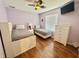 Bedroom with hardwood floors, ceiling fan and two beds at 315 Wildflower Rd, Davenport, FL 33837