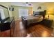 Inviting bedroom with wood floors, ceiling fan, and a large window providing plenty of natural light at 315 Wildflower Rd, Davenport, FL 33837