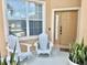 Inviting front porch with seating and decorative plants creating a welcoming entrance at 315 Wildflower Rd, Davenport, FL 33837