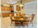 Cozy kitchen with wood cabinets and a dining area with six chairs at 315 Wildflower Rd, Davenport, FL 33837
