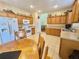 Functional kitchen with wooden cabinets and a bright dining area at 315 Wildflower Rd, Davenport, FL 33837