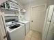 Laundry room with washer and dryer and storage shelves at 315 Wildflower Rd, Davenport, FL 33837