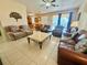 Spacious living room with tile flooring and multiple seating options, perfect for gatherings and relaxation at 315 Wildflower Rd, Davenport, FL 33837