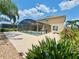 Exterior of house featuring a screened-in pool and patio area at 315 Wildflower Rd, Davenport, FL 33837