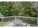Outdoor balcony with table and chairs overlooking a dense green space at 3151 Britannia Blvd # C, Kissimmee, FL 34747