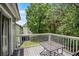 Outdoor balcony with table and chairs overlooking a lush green space at 3151 Britannia Blvd # C, Kissimmee, FL 34747