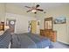 Bedroom featuring bed, dresser, ceiling fan, and bathroom access at 3151 Britannia Blvd # C, Kissimmee, FL 34747