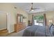 Bedroom featuring bed, dresser, ceiling fan, and sliding glass doors to deck at 3151 Britannia Blvd # C, Kissimmee, FL 34747
