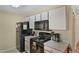 Functional kitchen with black appliances, white cabinets, and a view of the entryway at 3151 Britannia Blvd # C, Kissimmee, FL 34747