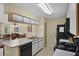 Open kitchen view with black appliances, white cabinets, and a view to the dining and living area at 3151 Britannia Blvd # C, Kissimmee, FL 34747