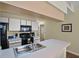 Well-lit kitchen featuring black appliances, white cabinets, a stainless steel sink, and neutral countertops at 3151 Britannia Blvd # C, Kissimmee, FL 34747