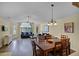 Bright living room with wood floors, a ceiling fan, and access to the dining area, perfect for entertaining and relaxing at 3151 Britannia Blvd # C, Kissimmee, FL 34747