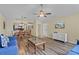 Spacious open-concept living area with wood floors, a dining table, and comfortable seating for modern living at 3151 Britannia Blvd # C, Kissimmee, FL 34747