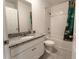 Bathroom featuring a white vanity with granite countertop, a toilet, and a shower with a patterned curtain at 3442 Monaco Ln, Davenport, FL 33897