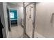 Modern bathroom featuring a glass-enclosed shower with white tiling and sleek fixtures, next to the bedroom at 3442 Monaco Ln, Davenport, FL 33897