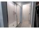 Bathroom featuring a spacious glass-enclosed shower with a view into a walk-in closet space at 3442 Monaco Ln, Davenport, FL 33897