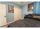 Comfortable bedroom with dark bedding, wood-look flooring, music posters and white closet doors at 3442 Monaco Ln, Davenport, FL 33897