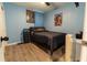 Bedroom boasts dark bedding, wood-look flooring, ceiling fan, and music posters at 3442 Monaco Ln, Davenport, FL 33897