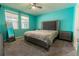 Comfortable bedroom featuring teal walls, carpet, a large bed, and matching nightstands at 3442 Monaco Ln, Davenport, FL 33897