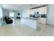 Open-concept kitchen with a granite island, white cabinetry, stainless appliances, and seamless flow to living area at 3442 Monaco Ln, Davenport, FL 33897