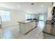 Bright, open kitchen with a granite island, stainless steel appliances, and seamless connection to the living room at 3442 Monaco Ln, Davenport, FL 33897